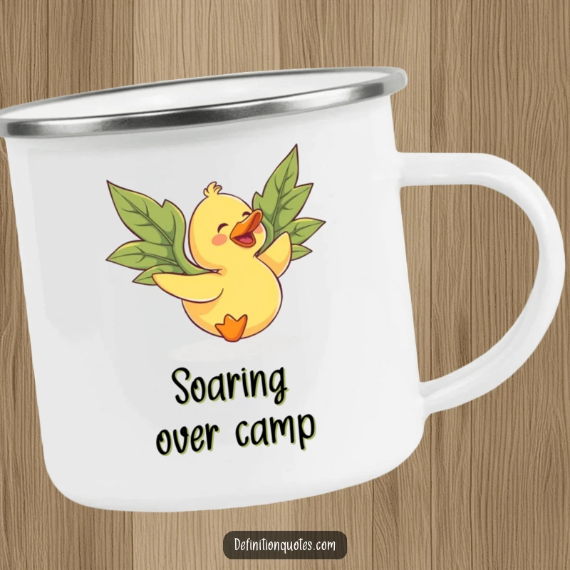 Funny rubber duck with leaf wings, gleefully attempting flight, on a durable camping mug for outdoor fun.