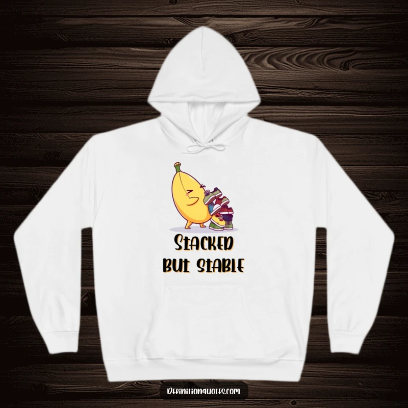Funny hoodie featuring a mischievous banana character balancing a pile of mismatched shoes, perfect for cozy, humorous wear.