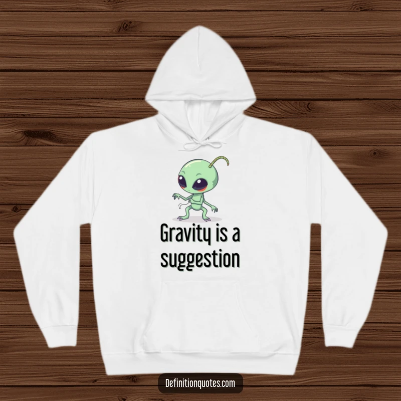 Funny clumsy alien tripping over long bendy antennae, depicted on a cozy hoodie, making a humorous statement about cosmic accidents.