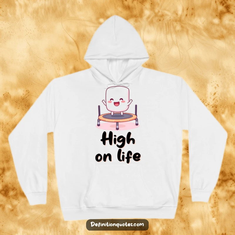 Funny hoodie featuring a cheerful marshmallow gleefully bouncing on a miniature trampoline, designed for cozy fun.