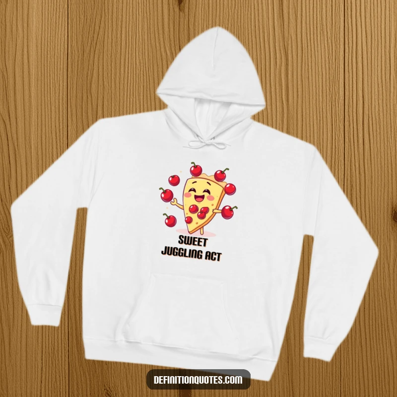 Funny slice of pie character on a hoodie enthusiastically juggling cherries, radiating amusement and dessert-themed fun.
